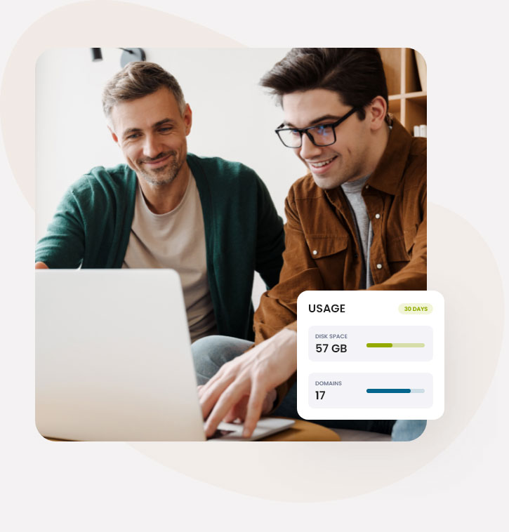 Two men reviewing disk space and domain usage on a laptop.