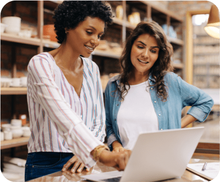 two women looking at a laptop